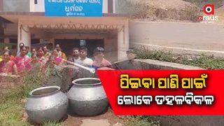 People are collecting water from the pipeline between the drains