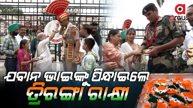 Womans tie Rakhi to BSF soldiers at the Attari Wagah border