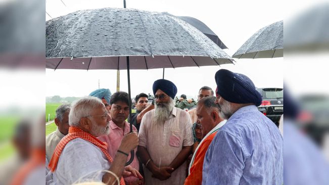 When PM Modi Held The Umbrella For Farmers...