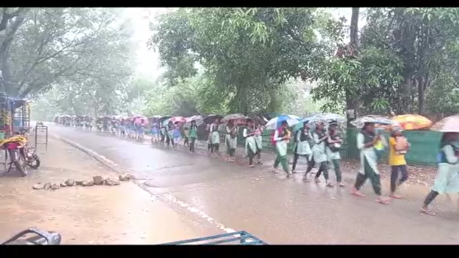 Hundreds of students are going to school in the pouring rain