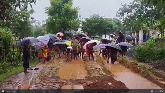 The truck is speeding on the muddy road